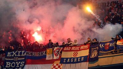 Croatia's supporters light flares and hurl them toward the pitch during the Euro 2016 qualifier between Italy and Croatia on Sunday in Milan. Matteo Bazzi / EPA