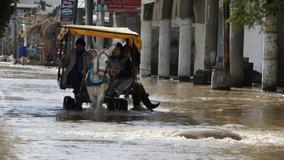 Palestinians ride a donkey cart across a flooded street following heavy rains in Gaza City. Adel Hana / AP Photo