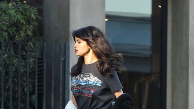 Selena Gomez wears the Car T-shirt and Rogue Bag from Coach. Courtesy of Splash News