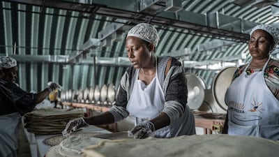 Women making injera, a traditional fermented flatbread, at the Lemi Kura factory in Addis Ababa, Ethiopia. AFP