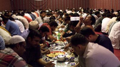 Men break the fast at the Sheikh Khalifa mosque in Mussaffah, Abu Dhabi. Christopher Pike / The National