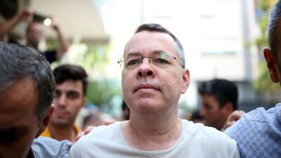 Pastor Andrew Brunso escorted by Turkish plain clothes police officers as he arrives at his house on July 25, 2018 in Izmir. AFP