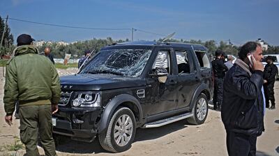 Hamas security officials inspect one of the cars of Palestinian Prime Minister Rami Hamdallah's convoy that was targeted in an attack after his arrival in Beit Hanun town, the northern Gaza Strip, March 13, 2018. Mohammed Saber / EPA