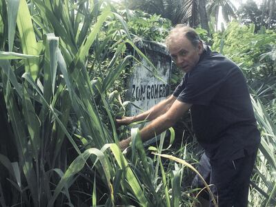 James Hanning uncovers an old sign for Zungomero. Courtesy James Hanning