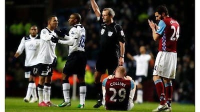 Referee Martin Atkinson, centre, shows Tottenham Hotspur's Jermaine Defoe, third left, the red card at Birmingham.