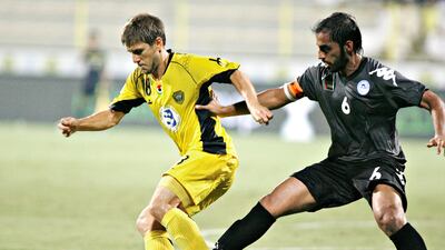 Al Wasl's Emiliano Alfaro shields the ball from Al Dhafra's Ali Msarri Al Dhaheri. Jeff Topping/The National