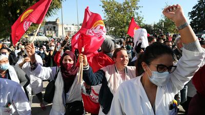 Tunisian health professionals take part in a demonstration demanding better working conditions in front of the Ministry of Health. Moody's says its downgrade of Tunisia's ratings reflects weak governance in the face of rising social constraints in the country. EPA