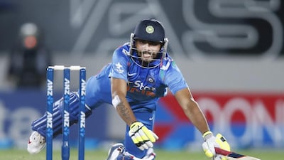 India's Ravindra Jajeda dives back to the crease as the ball misses the stumps on Saturday during the third one-day international against New Zealand. Nigel Marple / AFP