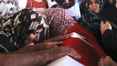 Relatives of Turkish diplomat Osman Kose cries on his coffin during his funeral ceremony in Ankara, Turkey, 18 July 2019. EPA