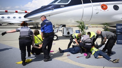 Environmental activists engage in a climate protest at the European Business Aviation Convention and Exhibition at Geneva Airport in Switzerland. EPA