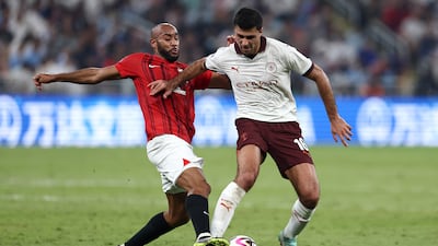 Rodri of Manchester City, right, is challenged by Jose Kante of Urawa Reds during the Fifa Club World Cup semi-final. Getty Images
