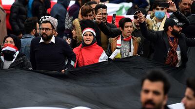 Iraqi university students carry the Iraqi national flag during a strike and protests in central Baghdad, Iraq. EPA