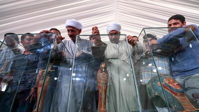Funerary masks on display during the unveiling of an ancient treasure trove of more than a 100 intact sarcophagi. AFP