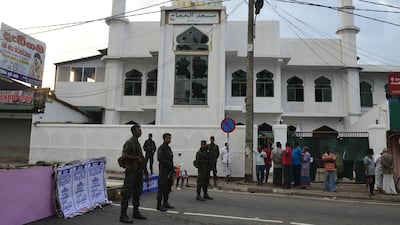 Security personnel stand guard in front of the Jumha mosque after a mob attack in Minuwangoda, Sri Lanka. AFP