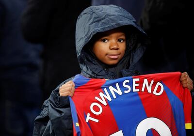 A young Crystal Palace supporter holds Andros Townsend's shirt after their unexpected win over Manchester City at Etihad Stadium on Saturday. Reuters
