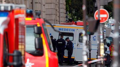 Police officers stand next to an ambulance near Paris prefecture de police (police headquarters) after four officers were killed in a knife attack. AFP