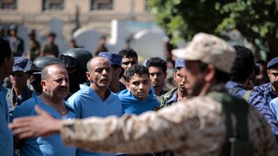 Police guard men convicted over the killing of a senior Houthi official before their execution at Tahrir Square in Sanaa, Yemen, on September 18. AP Photo