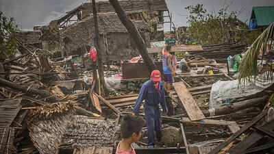 Residents try to salvage belongings in San Policarpio town, Eastern Samar province. AFP