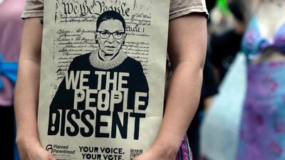 A demonstrator carries a print of women’s rights champion Ginsburg as abortion rights activists march in protest against the overturning of the Roe v Wade verdict. AFP
