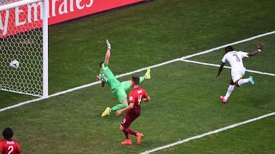 Ghana's Asamoah Gyan scores past Portugal keeper Beto on Thursday to make it 1-1 on Thursday at the 2014 World Cup. Christopher Lee / Getty Images