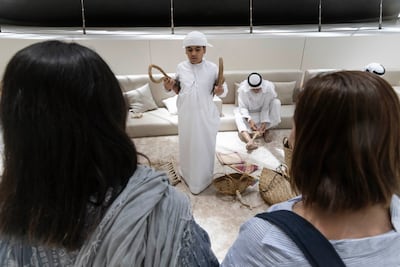 Ahmed Mohammed Al Aydaroos explains the traditional uses of palm-fibre rope and woven baskets. Antonie Robertson / The National