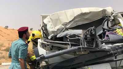 An officer inspects a vehicle in which three people died. Courtesy: UAQ Police