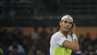 Rafael Nadal of Indian Aces adjust his hair as he plays Roger Federer of UAE Royals in the men's singles event of the International Premier Tennis League in New Delhi, India, Saturday, Dec. 12, 2015. Tsering Topgyal / AP Photo
