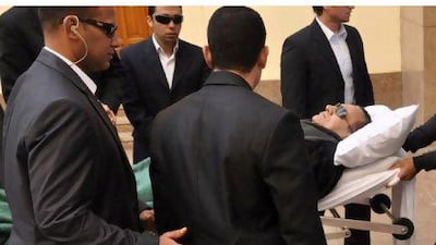 Former Egyptian president Hosni Mubarak is wheeled into a court house in Cairo, Egypt, Tuesday, Jan. 3, 2012. The chief prosecutor Mustafa Suleiman, in Hosni Mubarak's trial accused the ousted Egyptian leader on Tuesday of imposing "tyrannical rule" and devoting the last 10-years of his three decades in power to ensure his son would succeed him. (AP Photo/Mohammed al-Law) *** Local Caption *** APTOPIX Mideast Egypt.JPEG-007a9.jpg