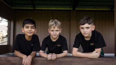 From right, pupils Musa Ahmed, Alfie Thomas and Dylan Thomas are learning to care for bees. Antonie Robertson / The National