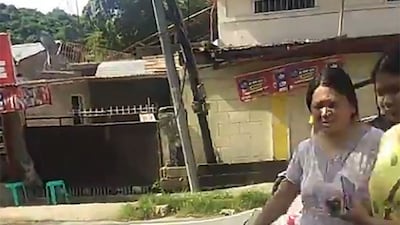 Residents cross a damaged road in the town of Bangued. AFP