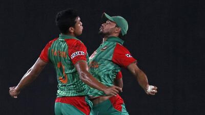 Taskin Ahmed and Mashrafe Mortaza, right, of Bangladesh celebrate during a T20 international match against Pakistan last month. AM Ahad / AP / April 24, 2015