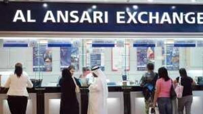 Customers queue at an exchange bureau at Al Wahda mall. These institutions often provide better transfer rates than banks.