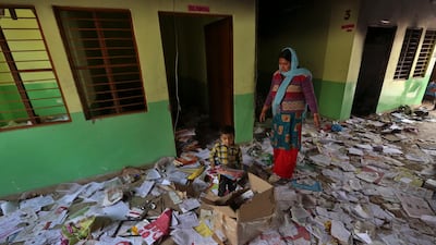 Books lie scattered at the Rajdhani Public School which was vandalized in Tuesday's violence at Shiv Vihar in New Delhi, India. AP