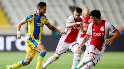 APOEL midfielder Musa Suliman is marked by Ajax defender Lisandro Martinez. AFP