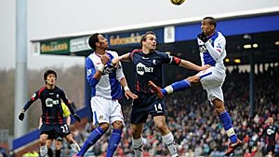 Steven Nzonzi and Martin Olsson, right, of Blackburn challenge the Bolton forward Kevin Davies.