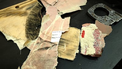 Debris from the car of Carlos Sainz's Ferrari after stopping on track during first practice. Getty