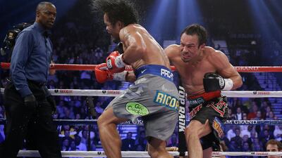 Marquez connects against Manny as referee Kenny Bayless looks on. AP Photo / Julie Jacobson