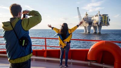 People observe an oil platform during their recent oil-platform viewing cruise on the Edda Fides in the North Sea off Norway. Thomas Mortveit / Reuters