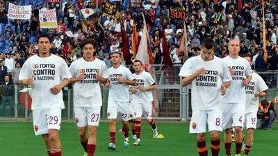 AS Roma's players, wearing jerseys against racism, warm-up before their Italian Serie A soccer match against Napoli at the Olympic stadium in Rome on May 19, 2013.