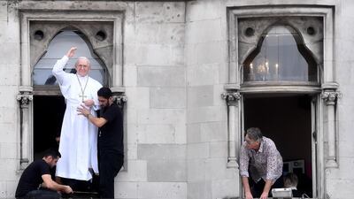 A model of a pope is placed in the window above a bar as crowds wait for Pope Francis. Getty Images