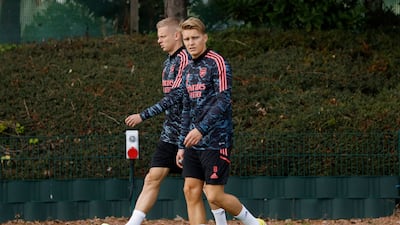 Arsenal's Martin Odegaard and Oleksandr Zinchenko arrive at training. Reuters