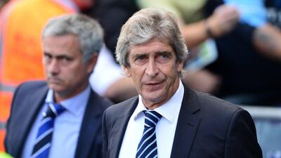 Manchester City's Chilean manager Manuel Pellegrini, right, shown during his side's 1-1 draw with Chelsea, managed by Jose Mourinho, left, on Sunday in the Premier League. Carl Court / AFP / September 21, 2014