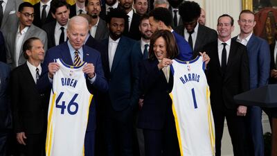 Curry presented Mr Biden and Ms Harris with their own Golden State jerseys. AP