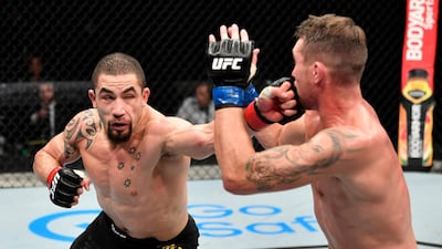 Robert Whittaker punches Darren Till. Getty
