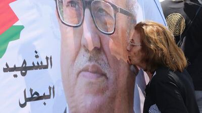 A protester kisses a portrait of murdered writer Nahed Hattar during a demonstration in front of the Jordanian prime minister's office on September 26, 2016. Khalil Mazraawi/AFP