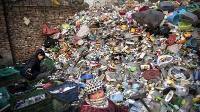 Chinese labourers sort plastics and other items collected to be recycled in the Dong Xiao Kou village. Kevin Frayer / Getty Images