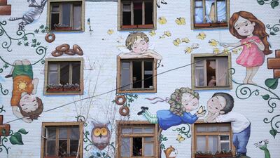 Residents look out of broken windows after a rocket attack in Kyiv. EPA