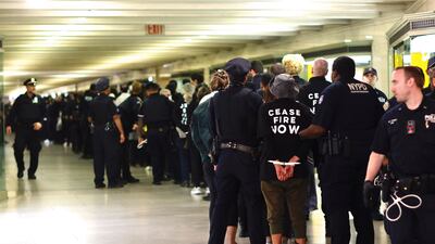 NYPD officers arrest protesters during a demonstration calling for a ceasefire amid war between Israel and Hamas, at Grand Central Station in New York City. AFP