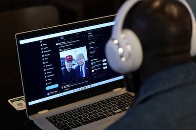 A person tries to watch the interview on the X social media network from New York. Reuters
