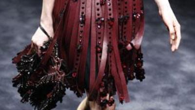 Prada's collection in Milan was simple and commercial. Here a model wears a slashed leather ribbon skirt with red crystals teamed with studded-frill Mary Janes.